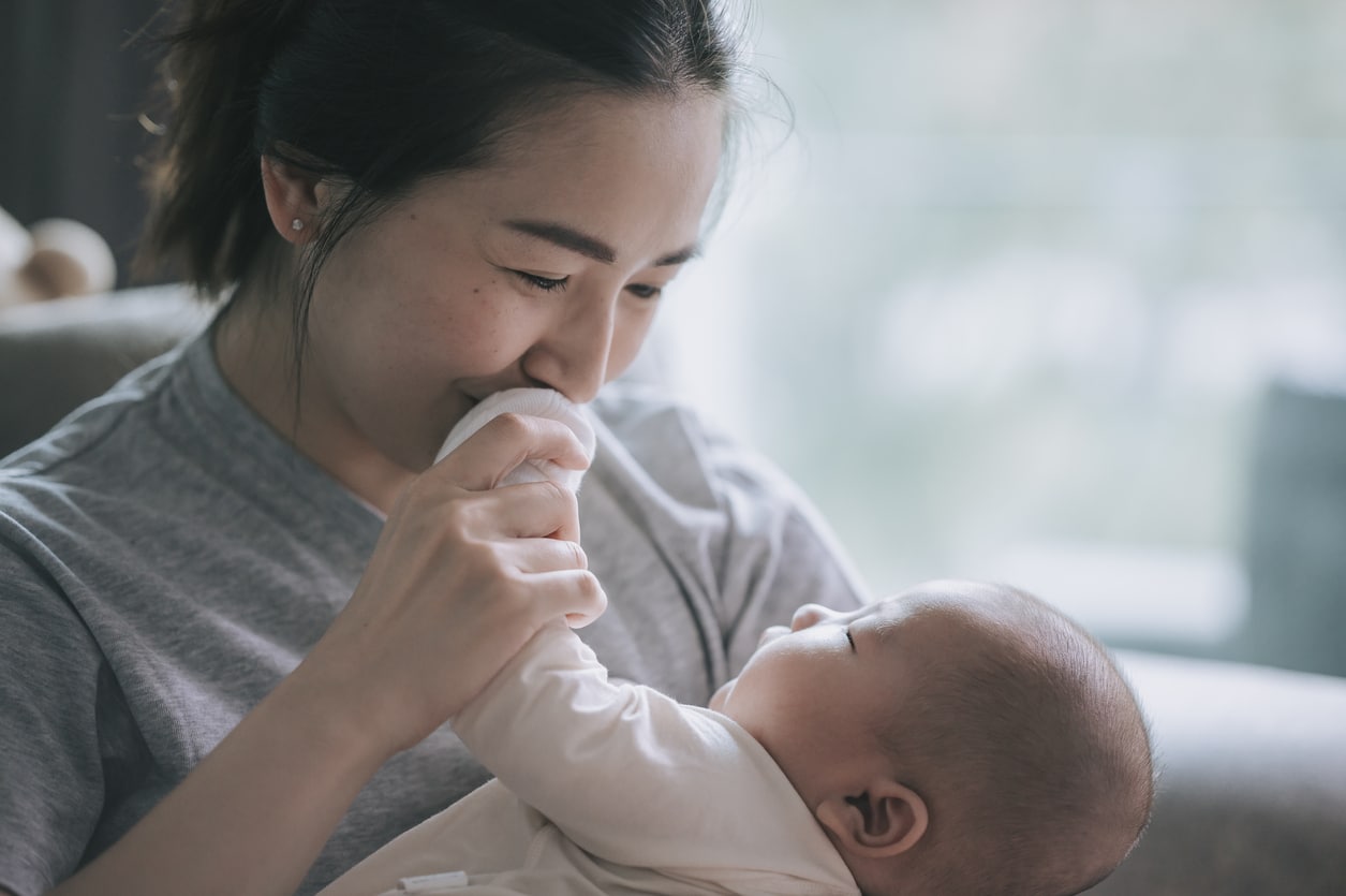 Asian Chinese Mother bonding time with her baby boy toddler at home