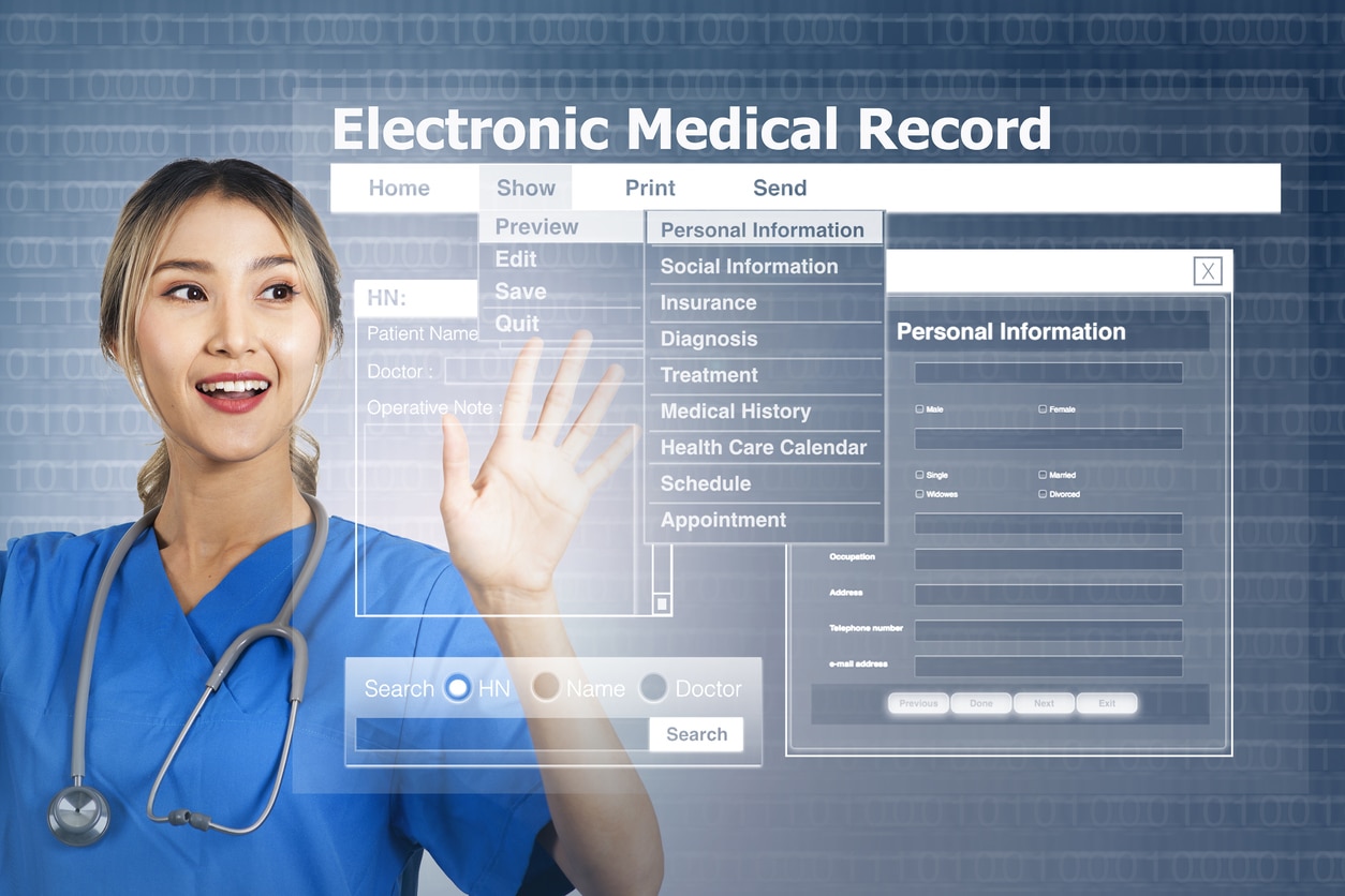 Female doctor with display screen showing electronic medical record.