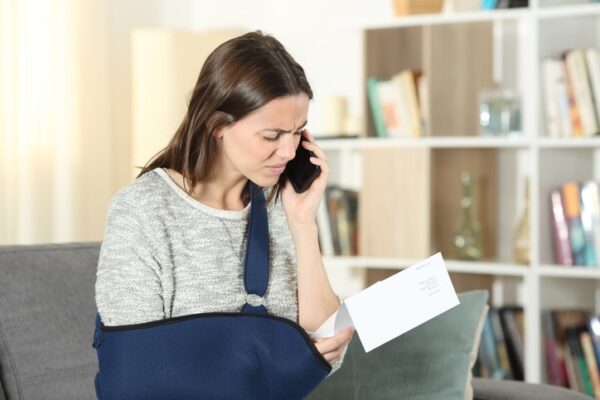 Accident settlement insurance tactics inujured woman on phone